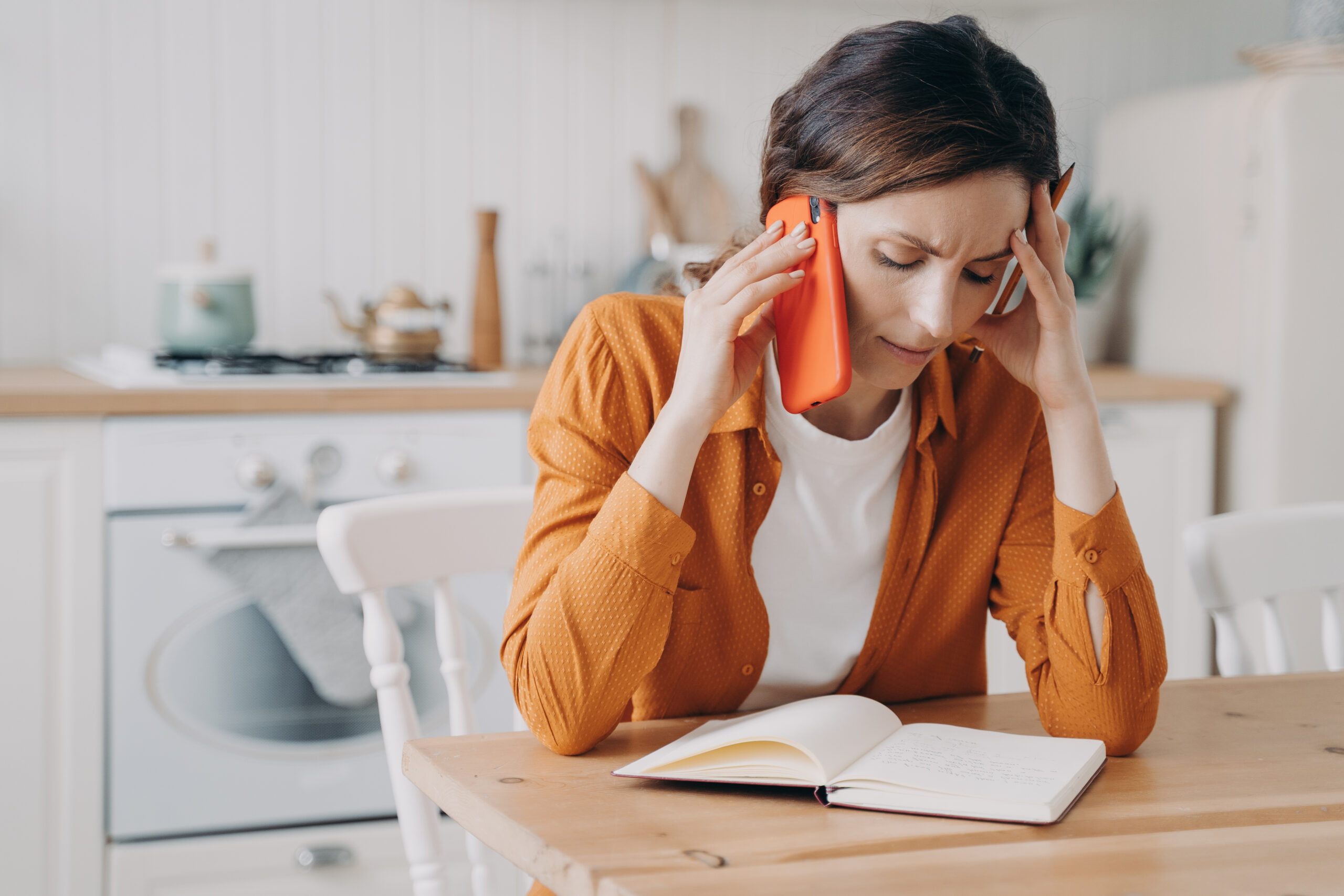 Female calling customer service, solving domestic problems by phone, hearing bad news in kitchen