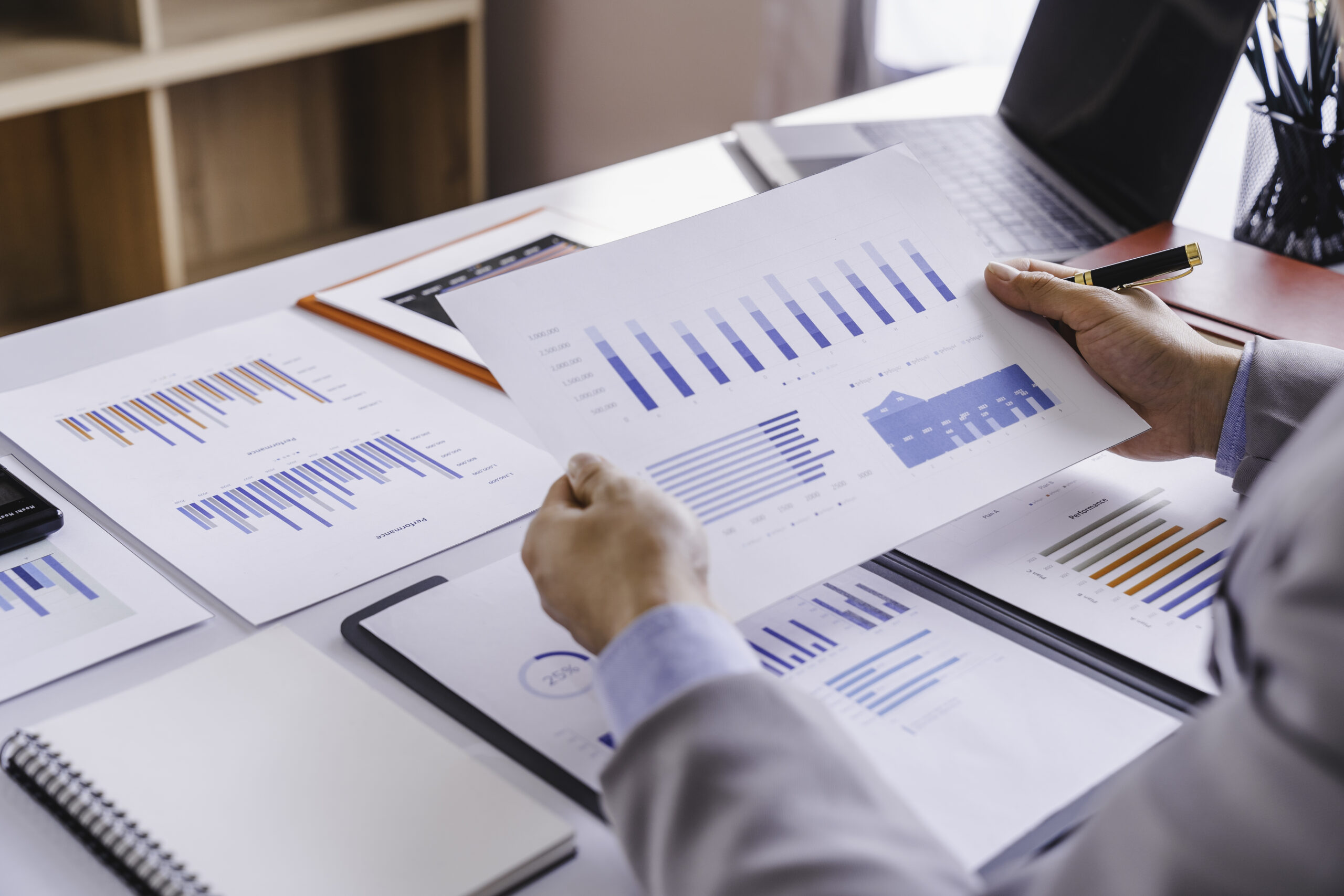 Hands of business people analyzing information in reports and making conclusion on company performance