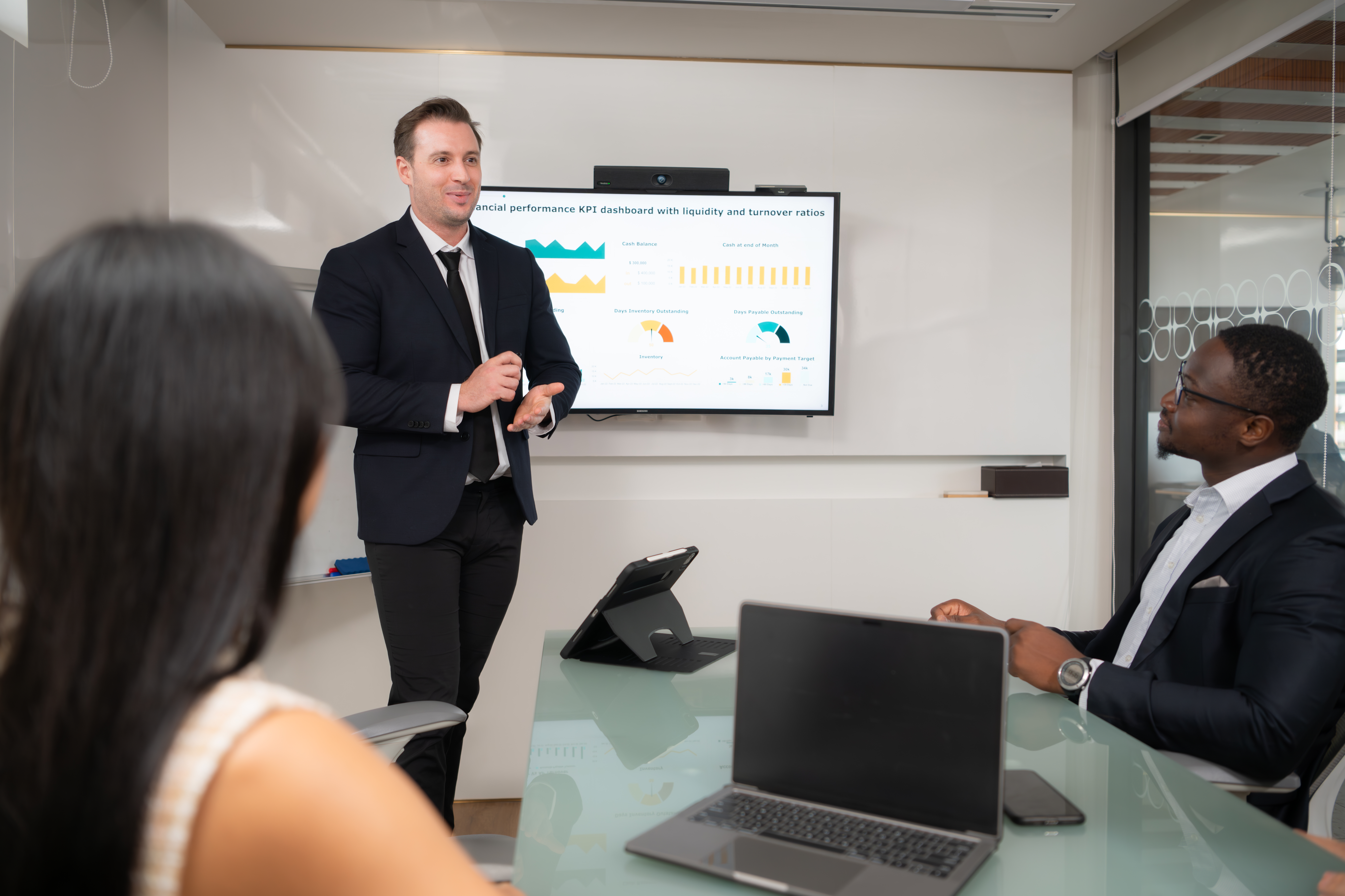 Rear view of two businesspeople having meeting around table in o