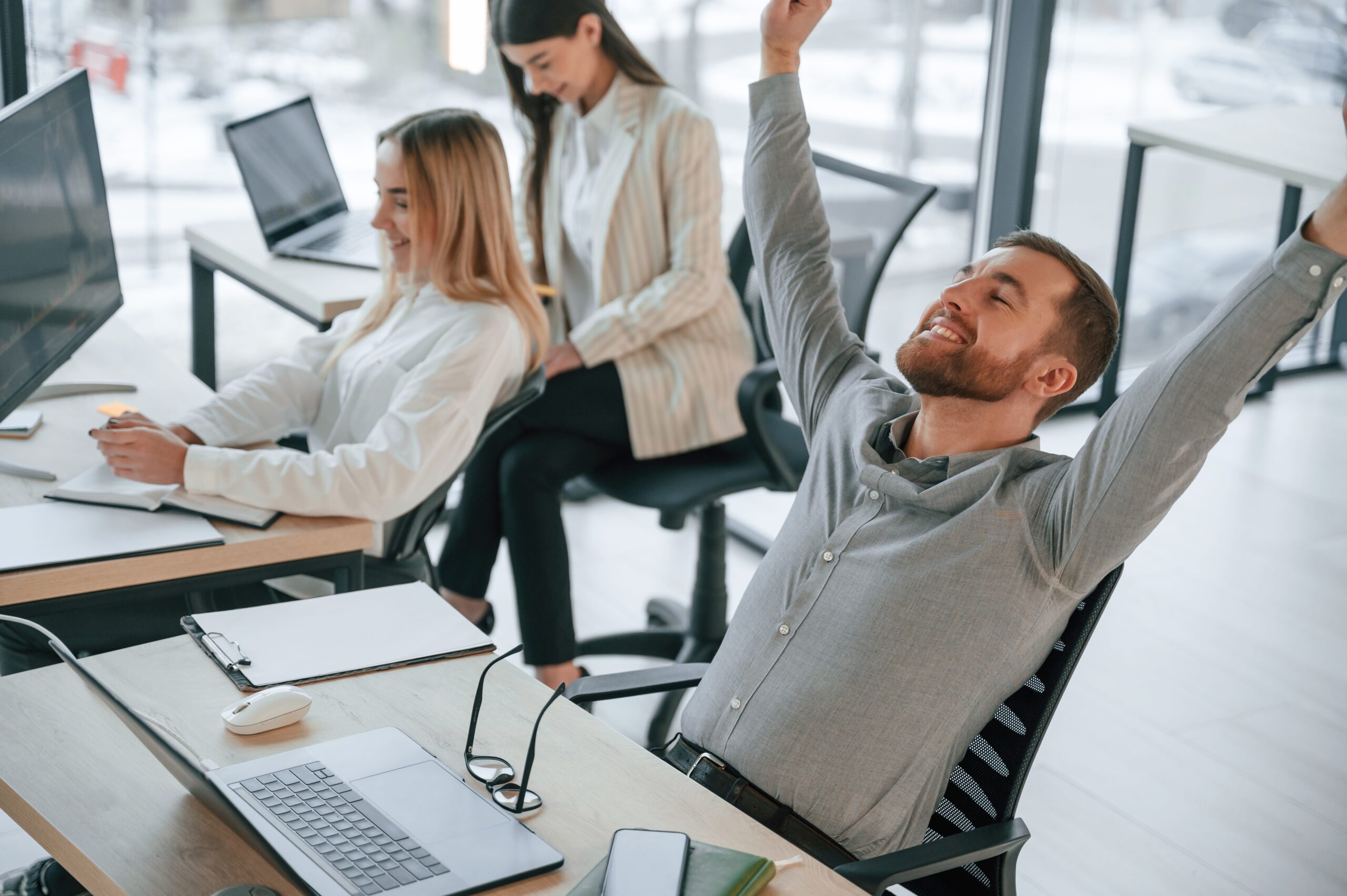 Man is satisfied about results. Successful team are working together in the office. Conception of business Man is satisfied about results. Successful team are working together in the office. Conception of business.